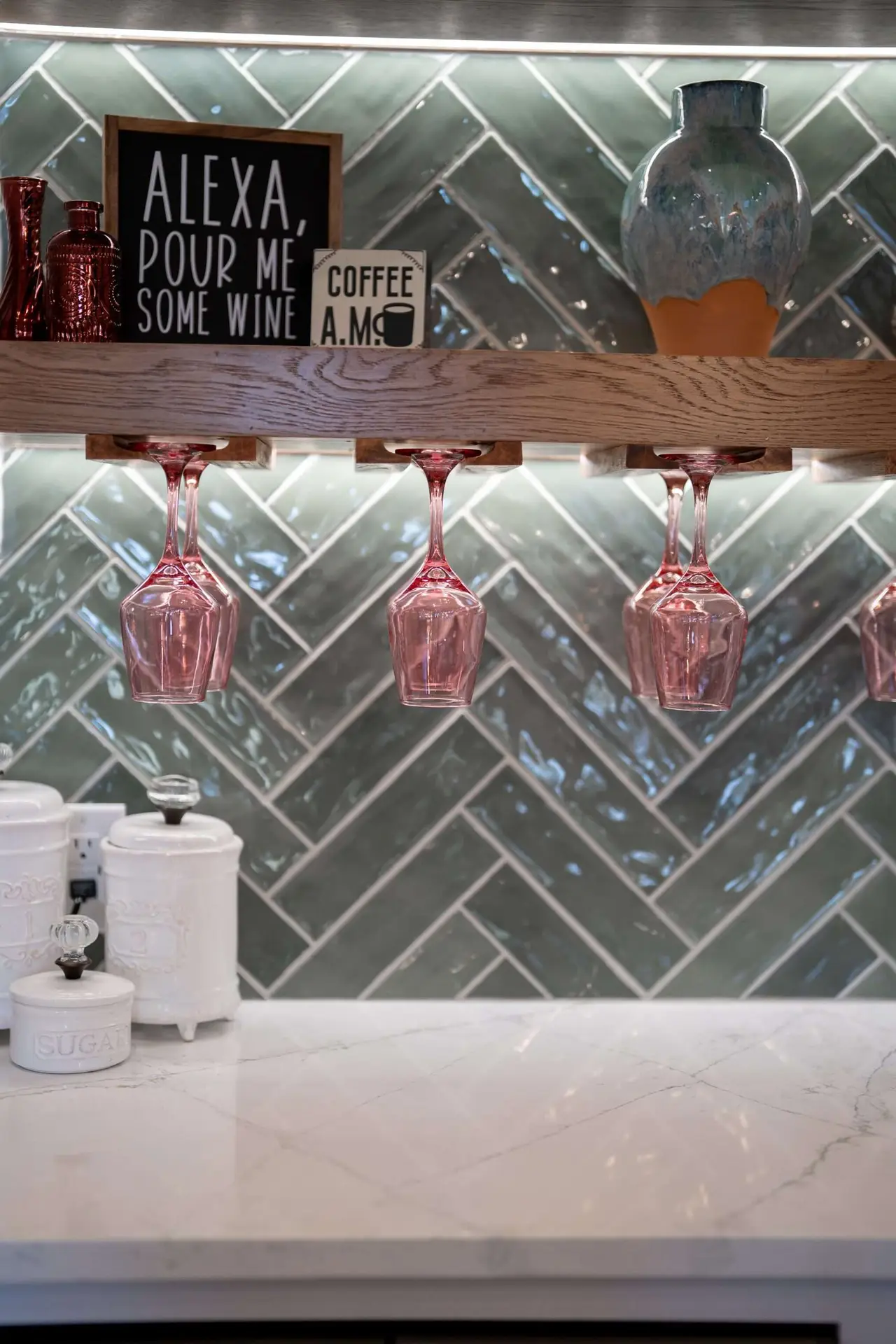 Green herringbone tile backsplash in kitchen